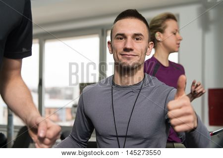 Personal Trainer Showing Ok Sign To Client
