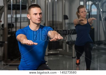 People Stretching During Fitness Class In Fitness Center