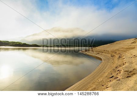 beautiful curve river with mountain cloudy fog and blue sky background at sunrise