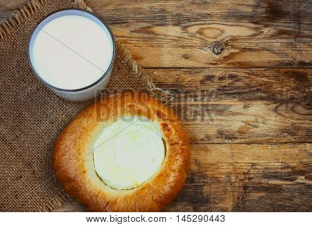 cheesecake with cottage glass of milk canvas cloth on wooden table