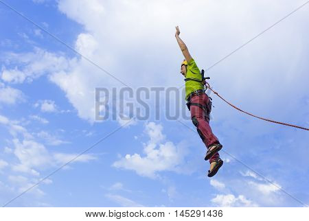 The first jump off the cliff with a safety rope.