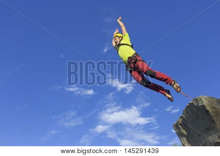 The first jump off the cliff with a safety rope.