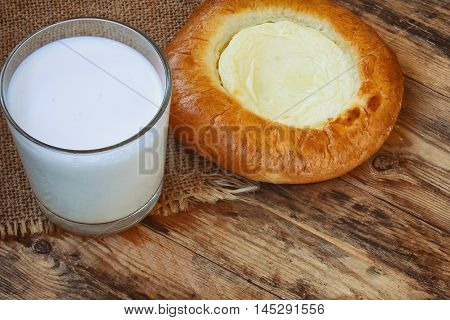 cheesecake cottage cheese glass of milk canvas doily on wooden table