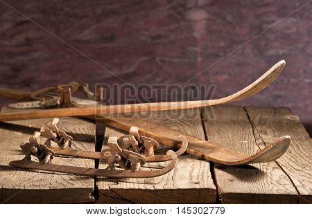 old skies and skates on the wooden table
