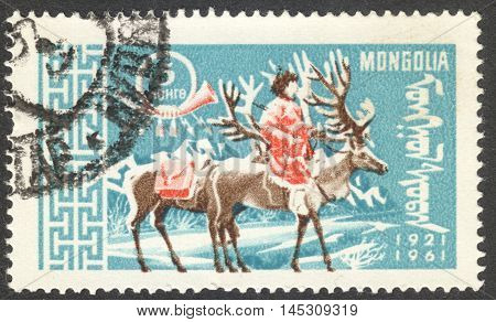 MOSCOW RUSSIA - CIRCA AUGUST 2016: a stamp printed in MONGOLIA shows a postman on Reindeer (Rangifer tarandus) the series 