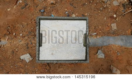 concrete manhole on ground and stone background