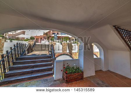 a white arcade in Poltu Quatu in Sardinia