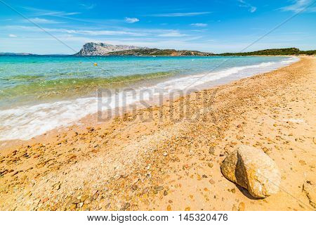 orange pebbles in Capo Coda Cavallo shore Sardinia