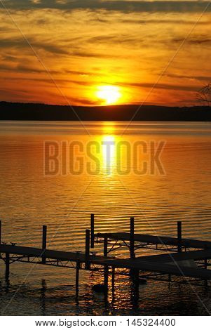 Colorful Sunset Overlooking a Boat Dock on a Large Lake