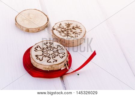 Homemade christmas ornament with red ribbbon on white background with copy space