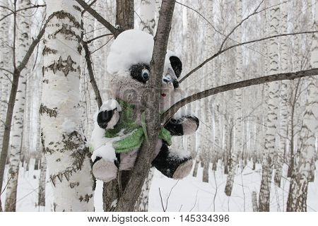 old rough rustic fence, made of logs, covered with snow