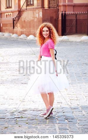 Young adult girl in purple keds and fluffy skirt. Teenager fashion.
