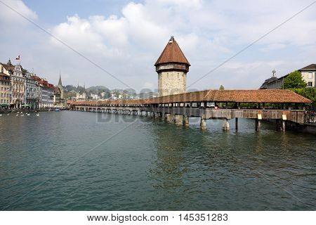 LUCERNE SWITZERLAND - MAY 02 2016: View towards octagonal tall tower (Wasserturm) together with the Chapel Bridge (Kapellbruecke) it is one of the Lucerne's most famous tourists attraction