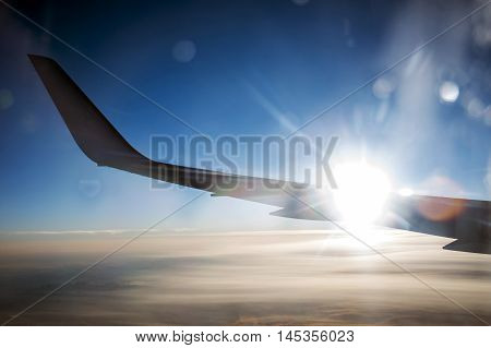 Airplane wing in the sunset flight to paradise