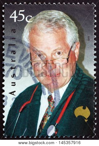 AUSTRALIA - CIRCA 2000: a stamp printed in Australia shows Dr. John Mathews with Stethoscope Face of Australia circa 2000