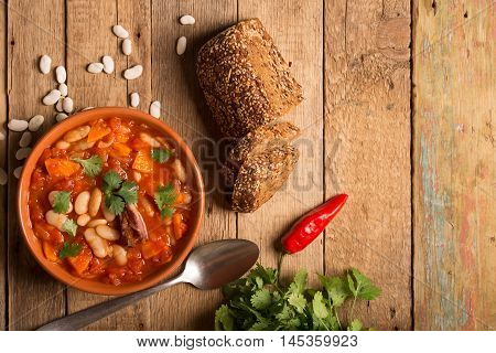 Rustic Kidney Bean Soup with beans and carrot. On the wooden table with copy space