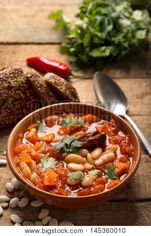Rustic Kidney Bean Soup with beans and carrot. On the wooden table