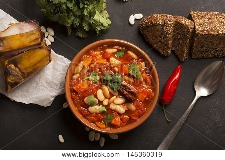 Rustic Kidney Bean Soup with beans and carrot. On the black chalkboard. Top view