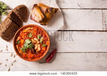 Rustic Kidney Bean Soup with beans and carrot. On the white wooden table