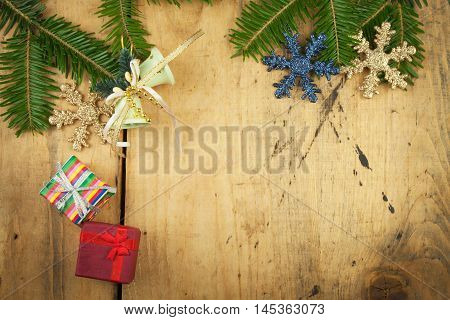 Christmas decoration on a wooden board. Christmas background. Christmas fir tree with decoration on a wooden board. Christmas background with balls and decorations over wooden table