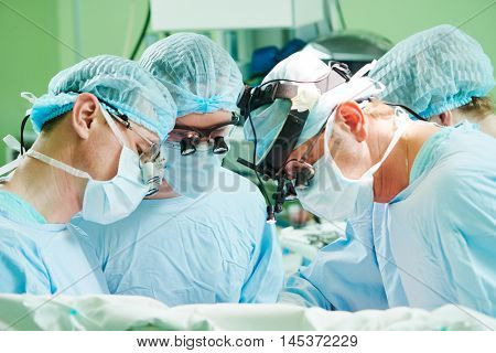 male cardiac surgeon at child cardiosurgery operating room