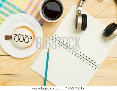 Blank book page on colorful pastel cafe wooden table