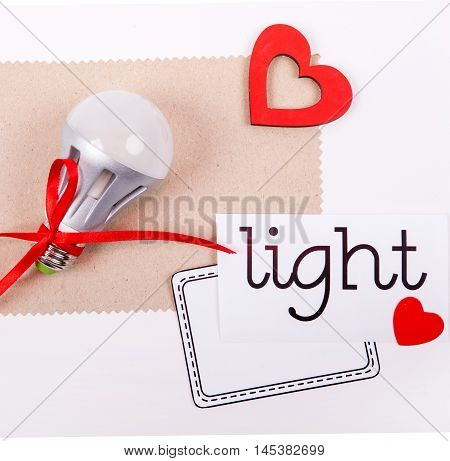 Energy saving lamp on a white background with a sign for the record