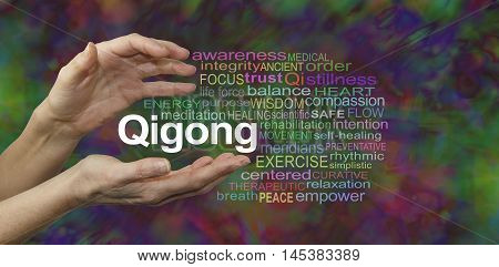 Qigong Healing word cloud - female cupped hands with the word QIGONG between surrounded by a word cloud on a rich dark multicolored background