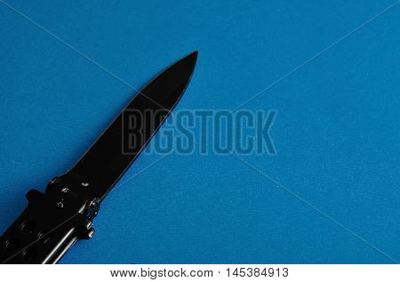 Steel butterfly knife (balisong) displayed on a colorful background