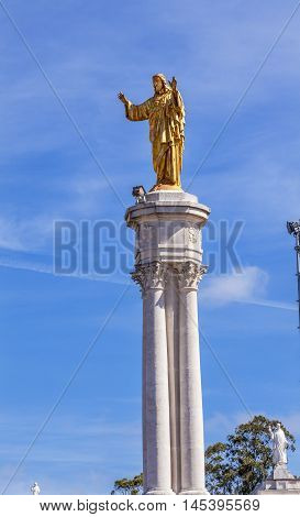 FATIMA, PORTUGAL - MAY 11, 2014 Golden Jesus Satue Basilica of Lady of Rosary Fatima Portugal. Church created on site where three Portuguese Shepherd children saw Virgin Mary of the Rosary. Basilica created in 1953.