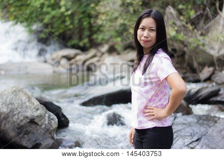 Thai woman with Mae Ya waterfall, Chiangmai Thailand
