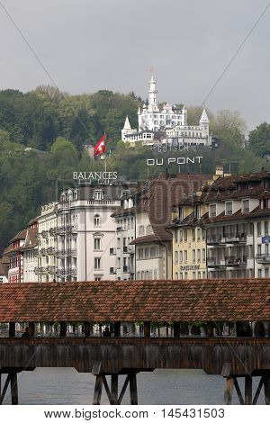 LUCERNE SWITZERLAND - MAY 04 2016: Gutsch castle with its hotel and restaurant towering over the buildings by the river Reuss. It shows the unique character and variety of sightseeing attractions