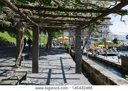 WEGGIS SWITZERLAND - MAY 05 2016: Pergola on the promenade extending along the shore of Lake Lucerne that is the perfect place to spend time and enjoy the beauty of nature
