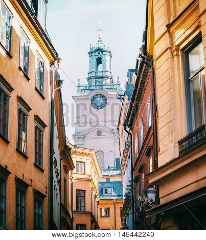 STOCKHOLM SWEDEN - OCTOBER 23 2014: View of the Cathedral of Saint Nicholas Sankt Nikolai kyrka or Storkyrkan Bell Tower beetwen houses in Stockholm Sweden.