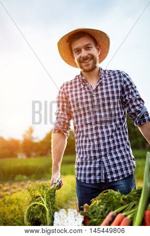 Likable farmer with smile on work in garden