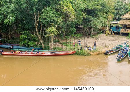 Lago Agrio Ecuador - 19 March 2015: Lago Agrio Tourists Loading Supplies On Wooden Boats Ready To Take Passengers To Cuyabeno National Park South America