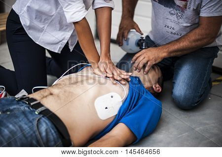 operators assisting an unconscious man with cardiopulmonary resuscitation