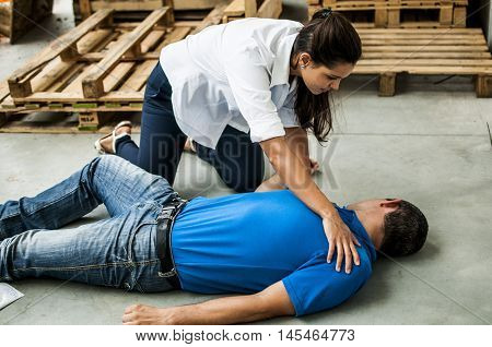 girl helping an unconscious man after heart attack