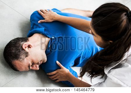 girl helping an unconscious man after heart attack