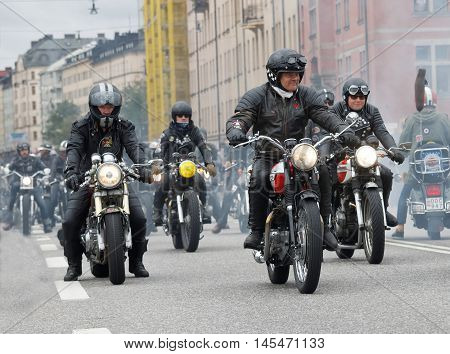STOCKHOLM SWEDEN - SEPT 03 2016: Group of bikers on old fashioned motorcycles at the Mods vs Rockers event at the Saint Eriks bridge Stockholm Sweden September 02 2016