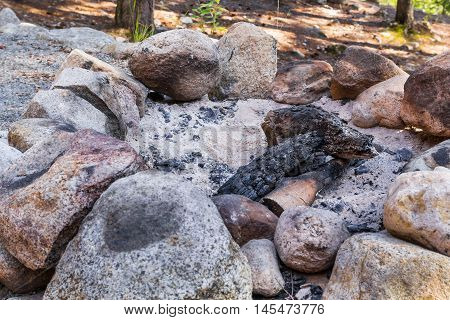 Photo of camp fire place with ashes