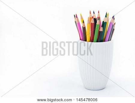 A stack of colored pencils on white background. Copy space