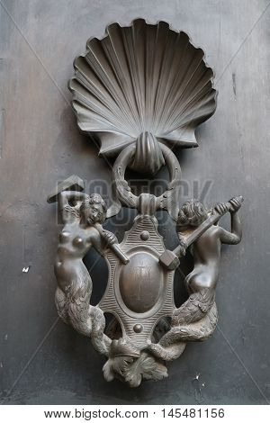 Old and ancient knocker in the city of Rome