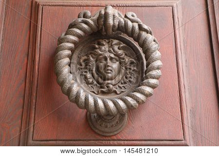 Old and ancient knocker in the city of Rome