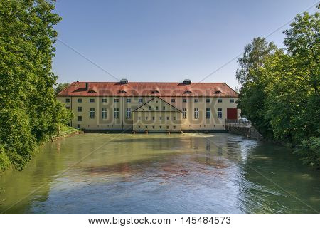 Building at the Isar-Werkkanal close to the Schinderbruecke in Munich with the Isar river passing by