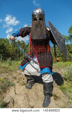 Mongol horde warrior in armour holding traditional saber