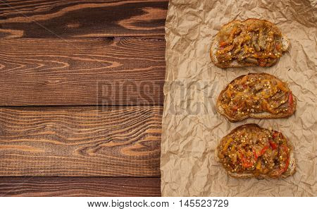 Vegetarian diet. Grain crispbread and appetizer of eggplant. Nutritious breakfast. wood background