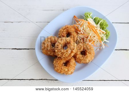 Fried Prawn Cake (tod mun kung) in blue dish on wooden background.