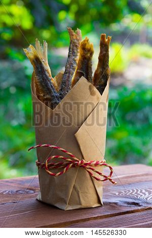 Lunch in nature, fried fish in a paper cup