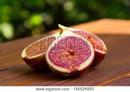 Fig slices on a brown wooden table